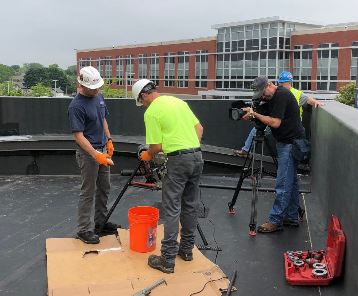 Dillett Mechanical Service Technicians threading gas pipe while being filmed for Wisconsin Builds TV Show 2